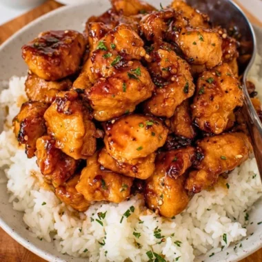 20-minute honey garlic chicken bites on a plate garnished with green onions.