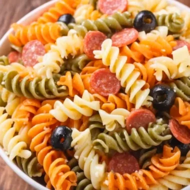 Bowl of easy and delicious Italian pasta salad with fresh vegetables and dressing