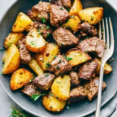 Delicious Garlic Butter Steak Bites served with golden, crispy potatoes.