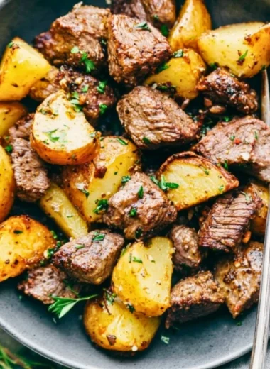 Delicious Garlic Butter Steak Bites served with golden, crispy potatoes.