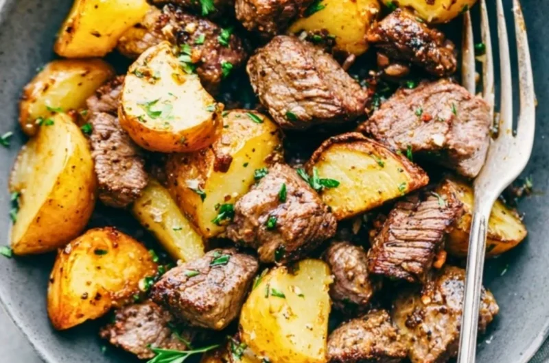 Delicious Garlic Butter Steak Bites served with golden, crispy potatoes.