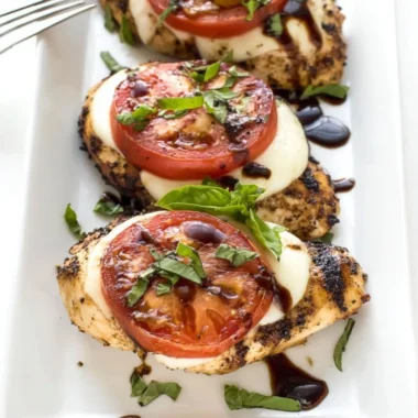 Delicious Grilled Chicken Caprese with basil and mozzarella on a plate