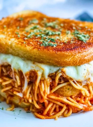 Spaghetti grilled cheese sandwich with melty cheese and pasta filling