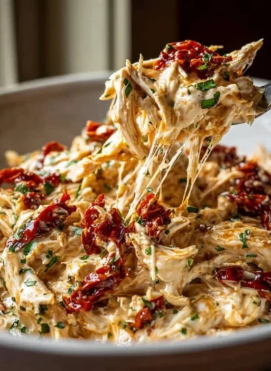 Creamy crockpot Marry Me Chicken served with herbs and pasta