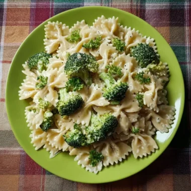 Creamy Broccoli Alfredo Pasta served in a bowl with fresh broccoli