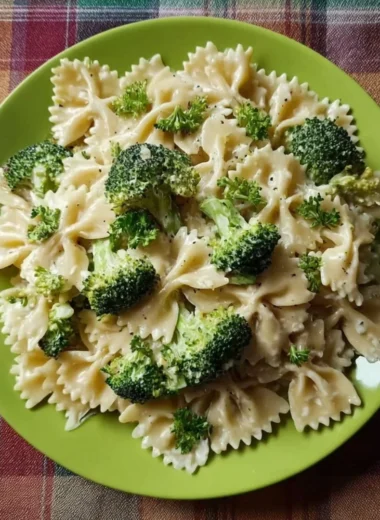 Creamy Broccoli Alfredo Pasta served in a bowl with fresh broccoli