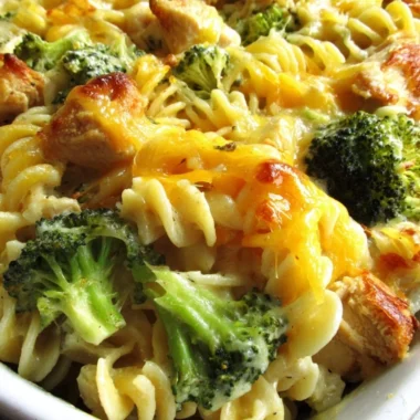 Cheesy broccoli chicken noodle casserole served in a baking dish