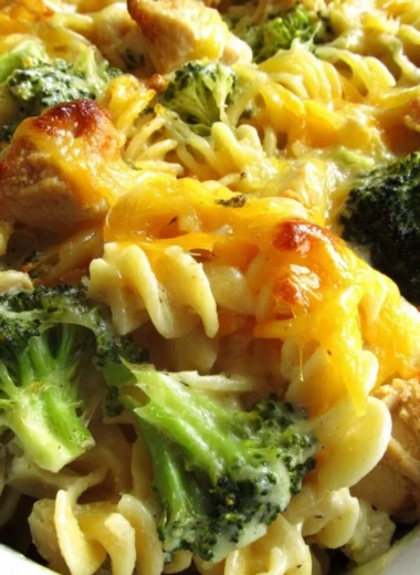 Cheesy broccoli chicken noodle casserole served in a baking dish