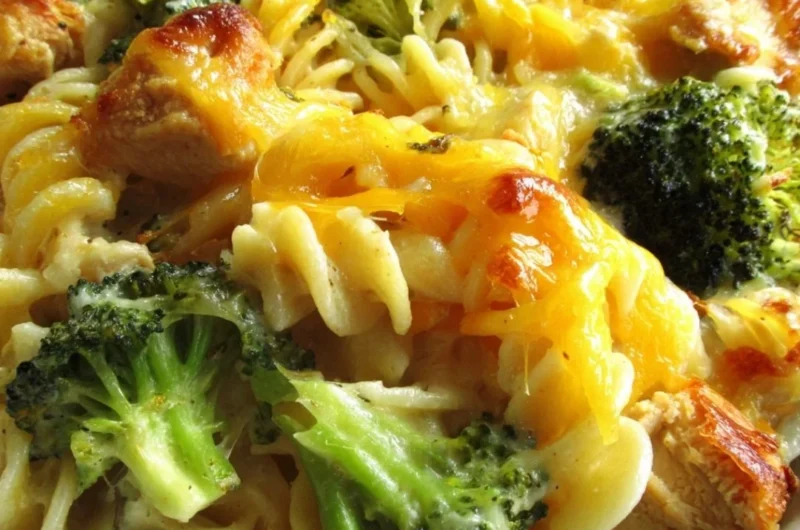 Cheesy broccoli chicken noodle casserole served in a baking dish