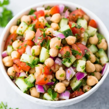 Colorful chickpea salad with fresh vegetables and herbs