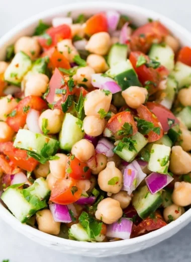 Colorful chickpea salad with fresh vegetables and herbs
