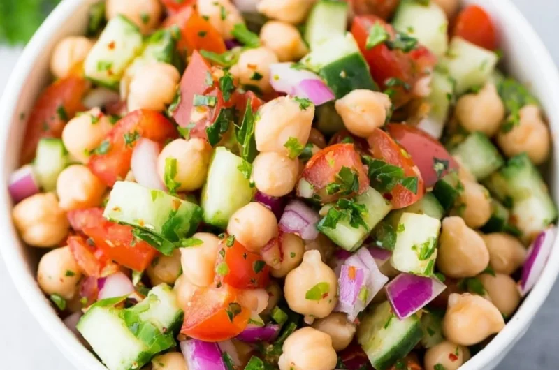 Colorful chickpea salad with fresh vegetables and herbs