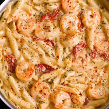 Delicious creamy shrimp pasta garnished with parsley and served in a bowl