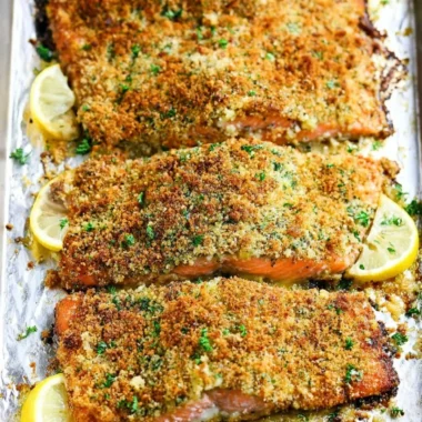 Plate of crispy garlic parmesan salmon garnished with herbs.