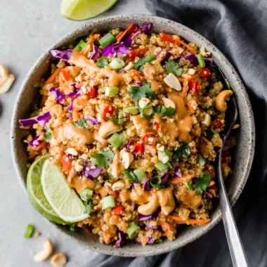 Crunchy Thai quinoa salad drizzled with ginger peanut dressing and fresh vegetables