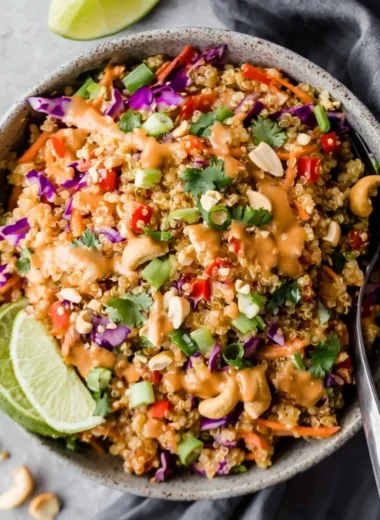 Crunchy Thai quinoa salad drizzled with ginger peanut dressing and fresh vegetables