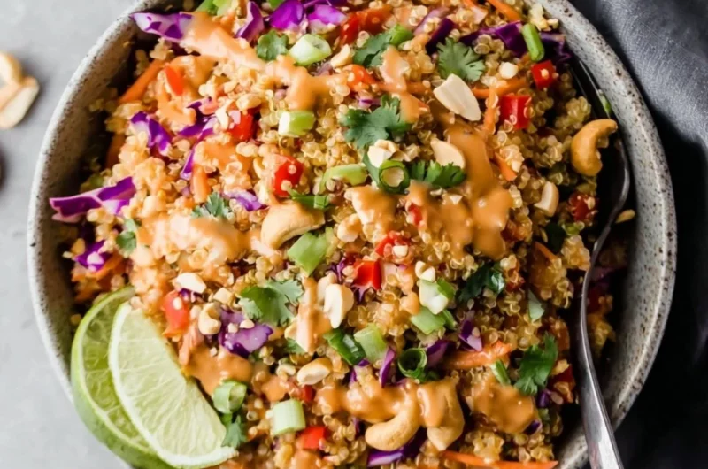 Crunchy Thai quinoa salad drizzled with ginger peanut dressing and fresh vegetables