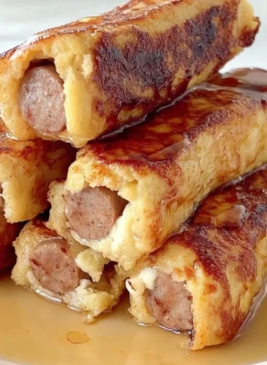 Delicious French Toast Roll-Ups filled with cream and topped with powdered sugar