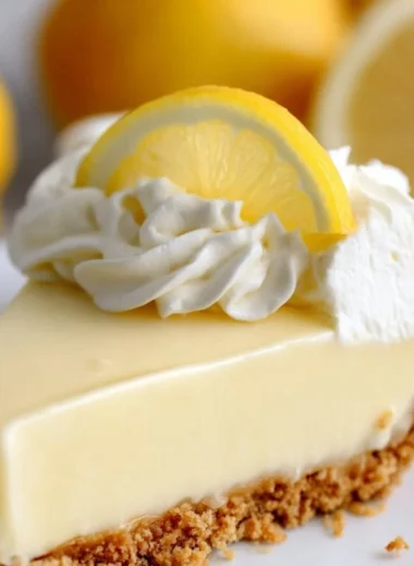Magnolia Lemon Pie with a slice on a plate, showcasing its creamy lemon filling and crust