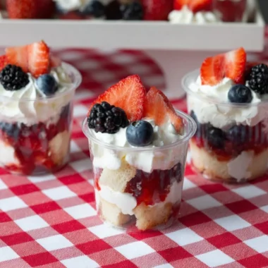 Delicious mini shortcake cups topped with fresh strawberries and whipped cream.