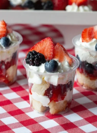 Delicious mini shortcake cups topped with fresh strawberries and whipped cream.