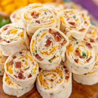 Colorful potluck pinwheels arranged on a platter for a party.