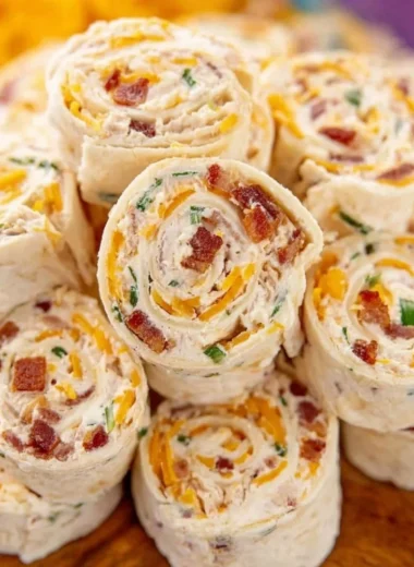 Colorful potluck pinwheels arranged on a platter for a party.