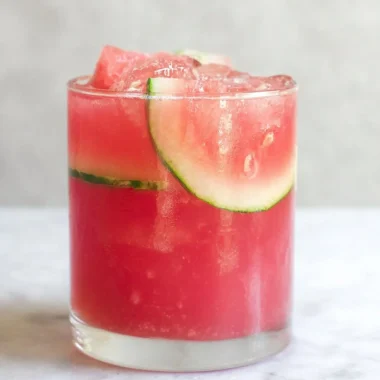 Refreshing watermelon cocktail punch served in a glass with mint garnish.