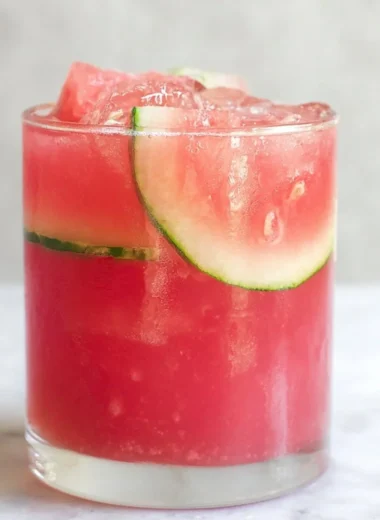 Refreshing watermelon cocktail punch served in a glass with mint garnish.