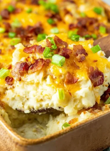 Twice baked potato casserole topped with cheese and green onions