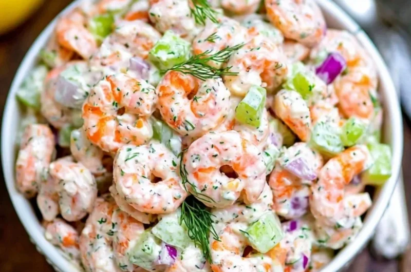 A vibrant bowl of ultimate shrimp salad with fresh vegetables and dressing