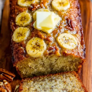 A loaf of delicious homemade banana bread on a wooden cutting board.