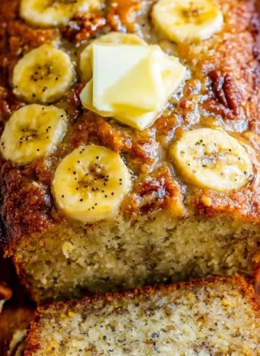 A loaf of delicious homemade banana bread on a wooden cutting board.
