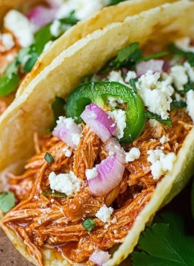 Authentic Chicken Tinga served in a taco with toppings
