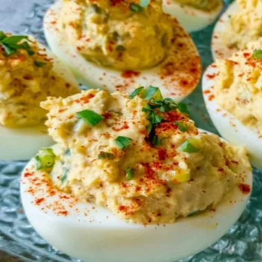 Plate of Cajun Deviled Eggs garnished with spices and herbs