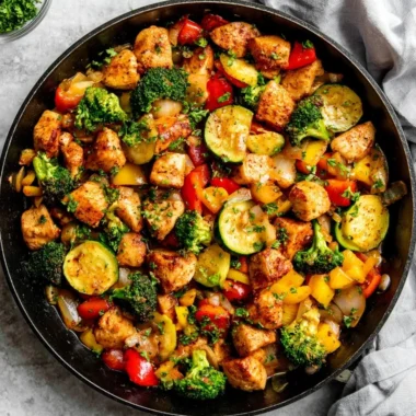 Chicken and vegetables skillet dish served in a cast iron pan