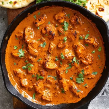 Delicious Chicken Tikka Masala served with naan and rice