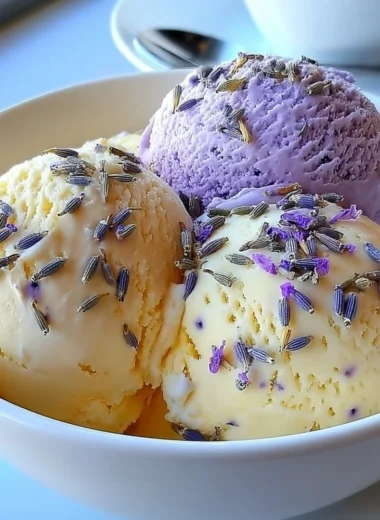 Creamy lavender honey ice cream in a bowl with lavender sprigs