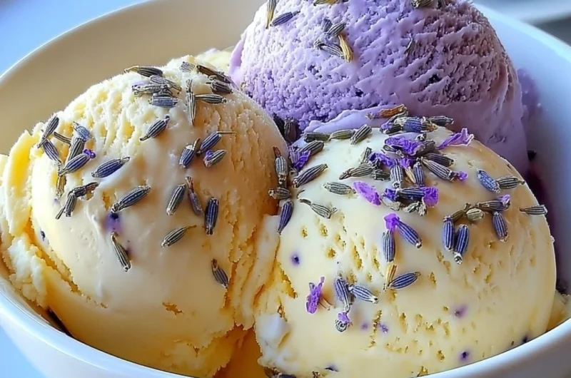 Creamy lavender honey ice cream in a bowl with lavender sprigs