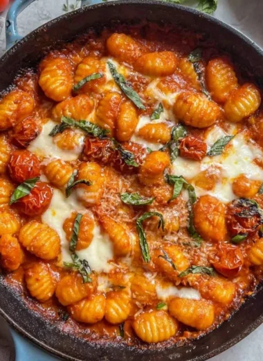 Creamy tomato gnocchi served in a bowl with fresh basil