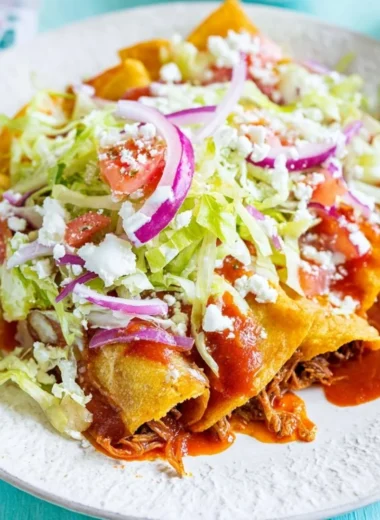 Plate of crispy golden tacos filled with fresh ingredients