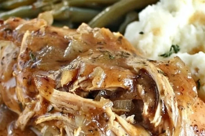 Crock Pot Mississippi Chicken served with sides on a rustic plate.