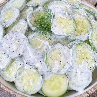 Cucumber salad with mayo and sour cream served in a bowl