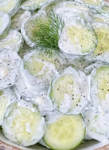 Cucumber salad with mayo and sour cream served in a bowl