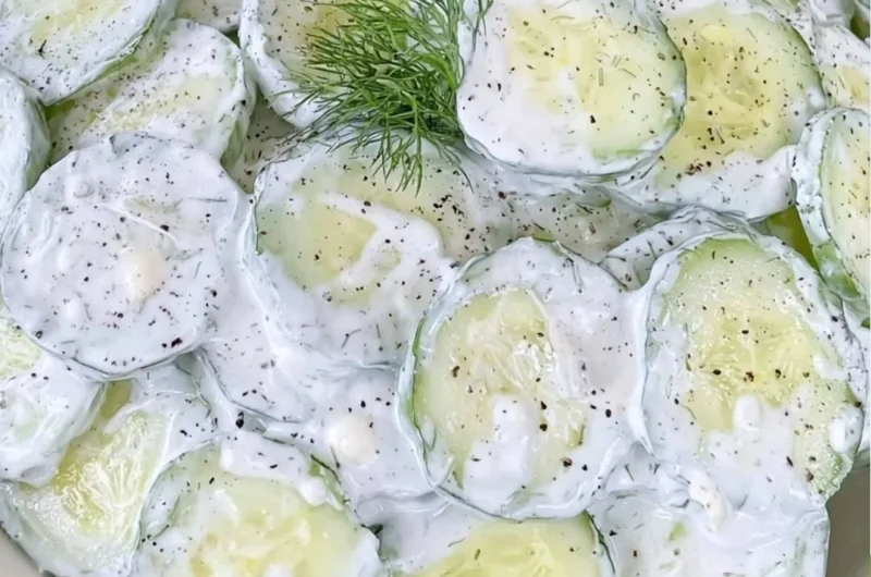 Cucumber salad with mayo and sour cream served in a bowl