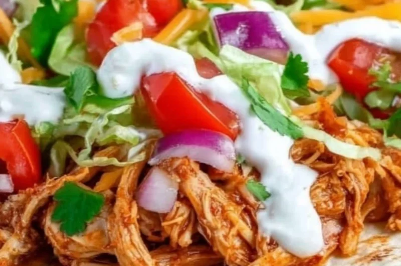 Delicious Mexican Pulled Chicken served in tacos with fresh toppings