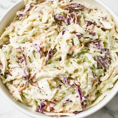 Bowl of perfectly balanced coleslaw salad with fresh vegetables and dressing