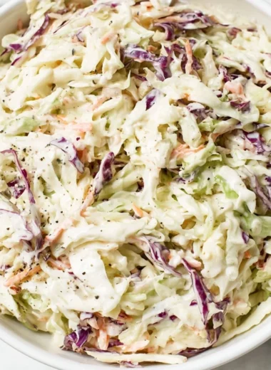 Bowl of perfectly balanced coleslaw salad with fresh vegetables and dressing