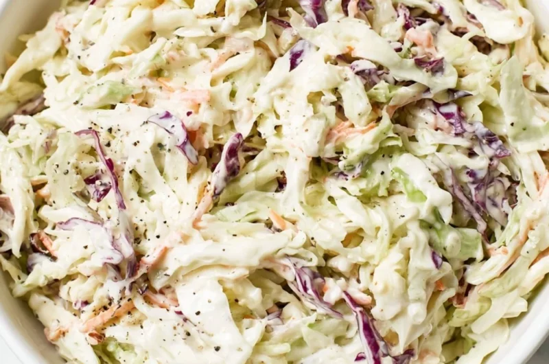 Bowl of perfectly balanced coleslaw salad with fresh vegetables and dressing