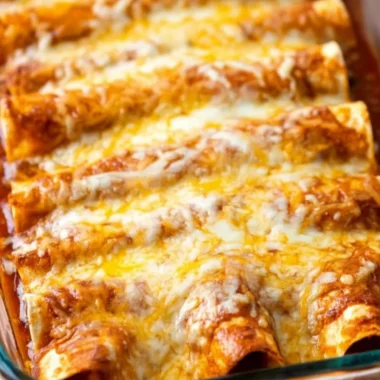 Delicious restaurant-style red cheese enchiladas topped with spicy red sauce and melted cheese.